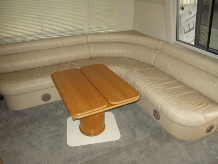 Spice Yacht Photos Pics Luxurious interior of 2000 Bayliner 5288 Pilot House with beige seating and wooden table.