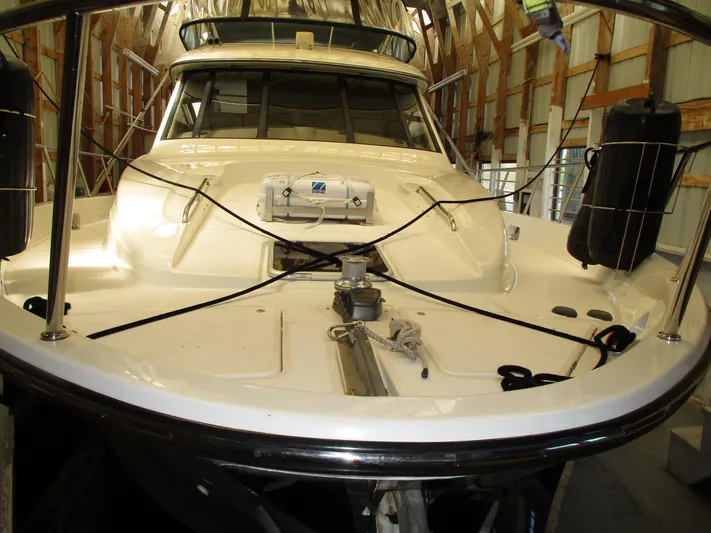 Spice Yacht Photos Pics Bayliner 5288 Pilot House 2000 in a boat shed, front view with deck details.