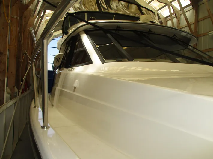 Spice Yacht Photos Pics 2000 Bayliner 5288 Pilot House yacht in storage, showcasing sleek design and structure.