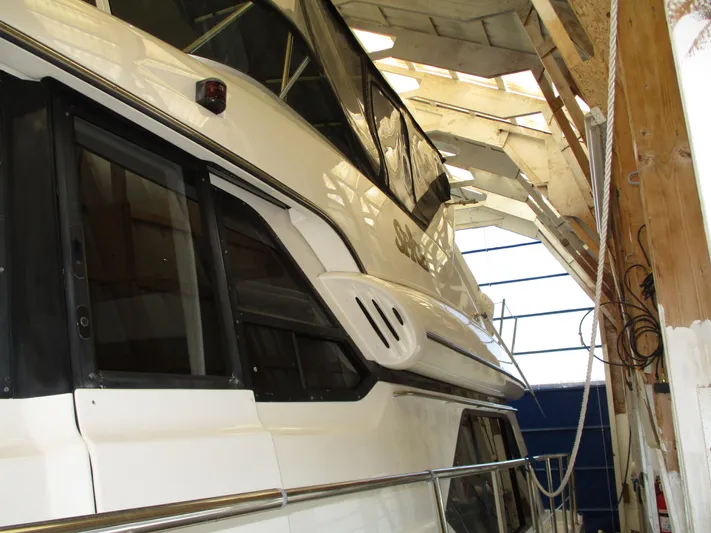 Spice Yacht Photos Pics 2000 Bayliner 5288 Pilot House yacht in a wooden boathouse.