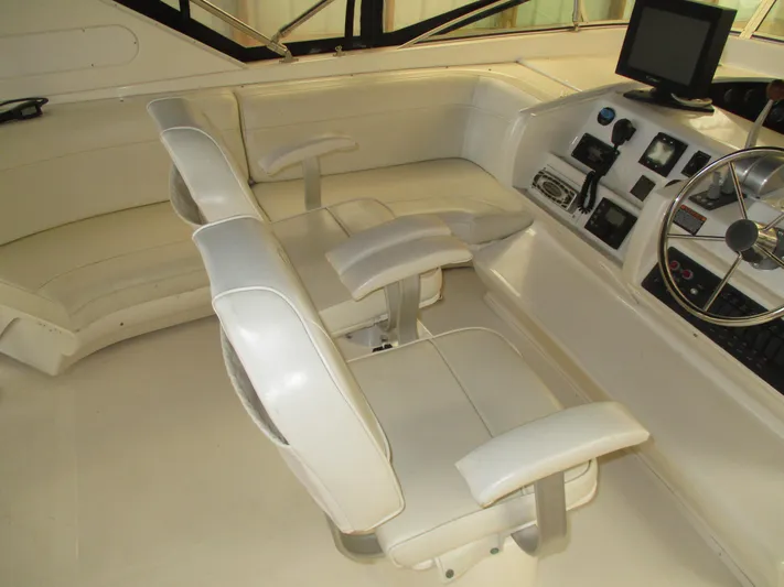 Spice Yacht Photos Pics 2000 Bayliner 5288 Pilot House interior with white seating and navigation controls.