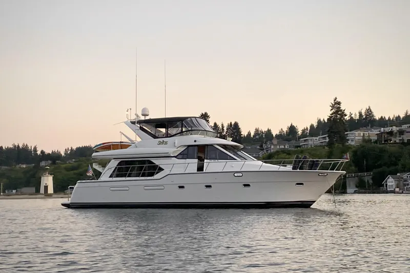 Spice Yacht Photos Pics Bayliner 5288 Pilot House 2000 yacht on calm water at sunset.