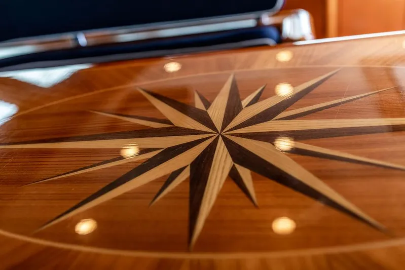 Cabochon Yacht Photos Pics Polished wooden table with compass rose design on 2004 Ta Chiao Custom Pilothouse Cutter.