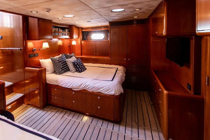 Cabochon Yacht Photos Pics Luxurious 2004 Ta Chiao Custom Pilothouse Cutter cabin with wood paneling and cozy bed.