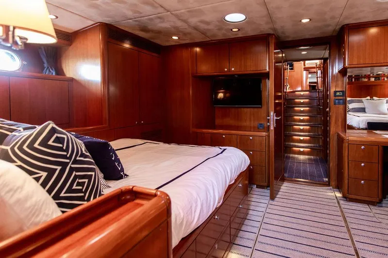 Cabochon Yacht Photos Pics Luxurious 2004 Ta Chiao Custom Pilothouse Cutter cabin with wood paneling and cozy bedding.