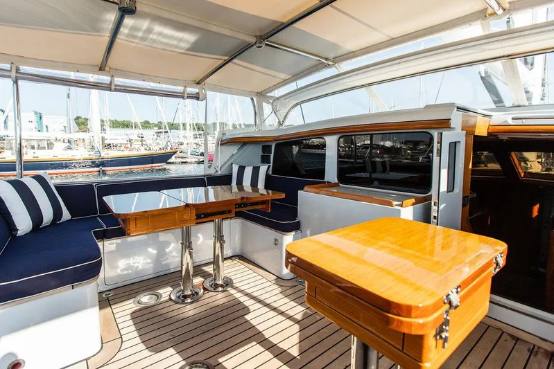 Cabochon Yacht Photos Pics Luxurious 2004 Ta Chiao Custom Pilothouse Cutter with elegant wood and navy seating.