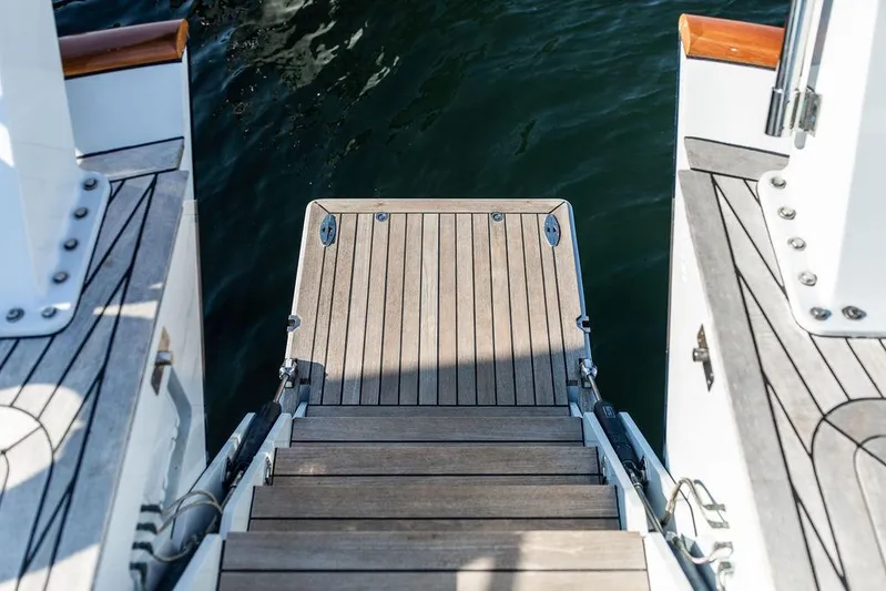 Cabochon Yacht Photos Pics Wooden steps leading to water on 2004 Ta Chiao Custom Pilothouse Cutter.