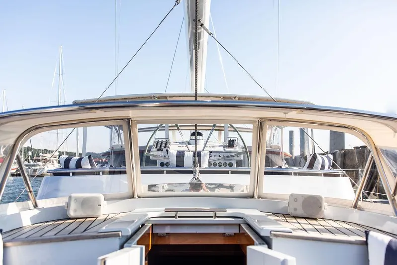 Cabochon Yacht Photos Pics 2004 Ta Chiao Custom Pilothouse Cutter yacht cockpit with striped cushions and clear skies.