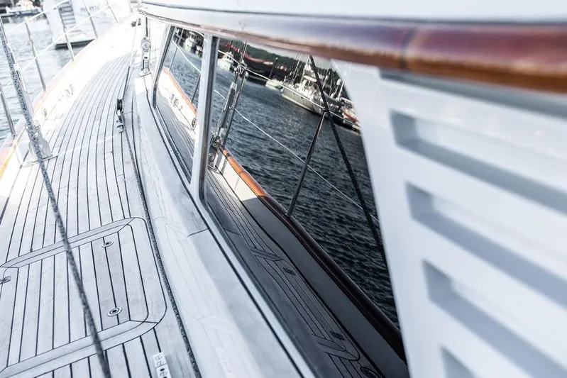 Cabochon Yacht Photos Pics 2004 Ta Chiao Custom Pilothouse Cutter deck with sleek wooden finish and reflective windows.