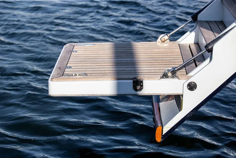 Cabochon Yacht Photos Pics Ta Chiao 2004 Custom Pilothouse Cutter swim platform over water.