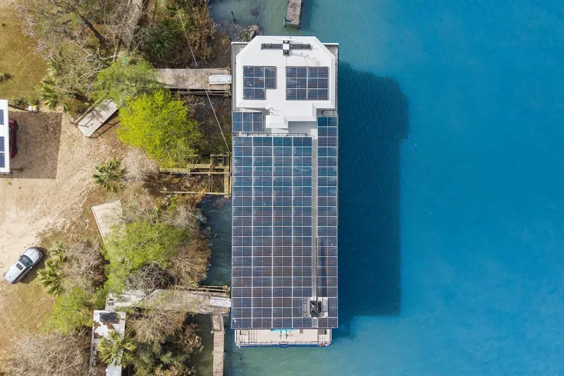 Shine Down Yacht Photos Pics Aerial view of 2025 Breaux Brothers 120 GLV boat with solar panels on blue water.