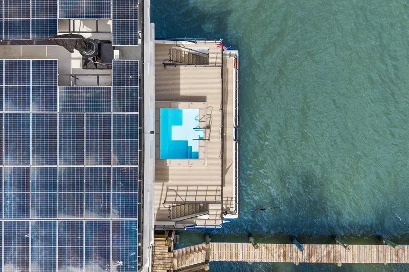 Shine Down Yacht Photos Pics Aerial view of Breaux Brothers 120 GLV yacht with solar panels and pool, 2025 model.