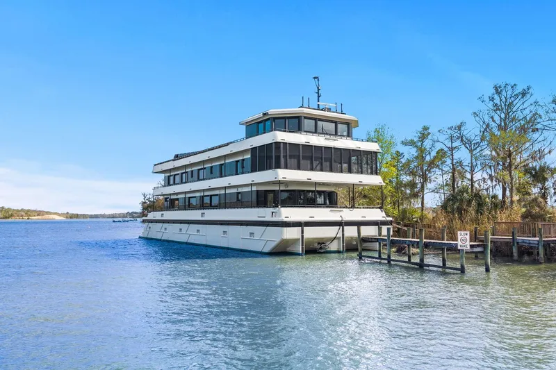 Shine Down Yacht Photos Pics Luxury Breaux Brothers 120 GLV yacht docked by a scenic shoreline, 2025 model.