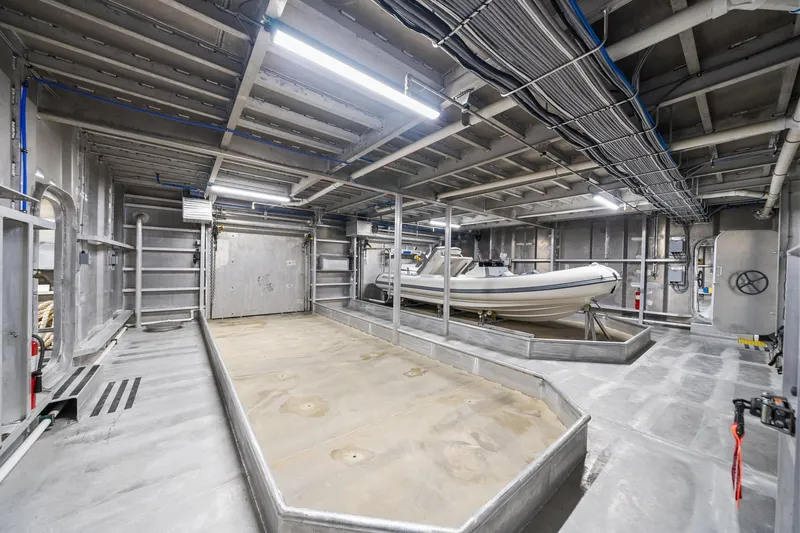 Shine Down Yacht Photos Pics Interior of 2025 Breaux Brothers 120 GLV yacht with stored inflatable boat.