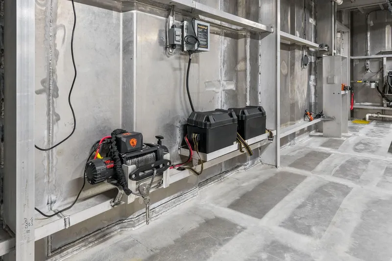 Shine Down Yacht Photos Pics Interior of 2025 Breaux Brothers 120 GLV boat, featuring equipment and storage compartments.