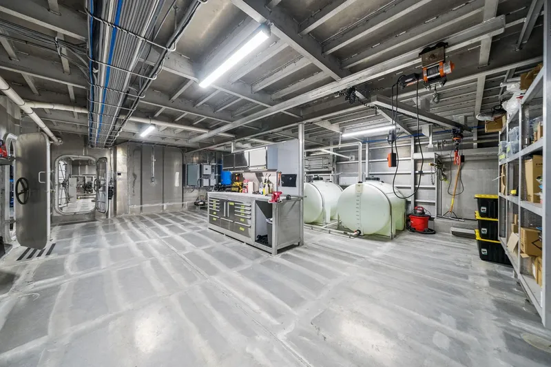 Shine Down Yacht Photos Pics Modern industrial interior of Breaux Brothers 120 GLV, 2025 model, featuring equipment and storage.