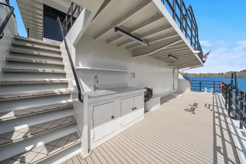 Shine Down Yacht Photos Pics Deck view of 2025 Breaux Brothers 120 GLV yacht with stairs and outdoor sink.