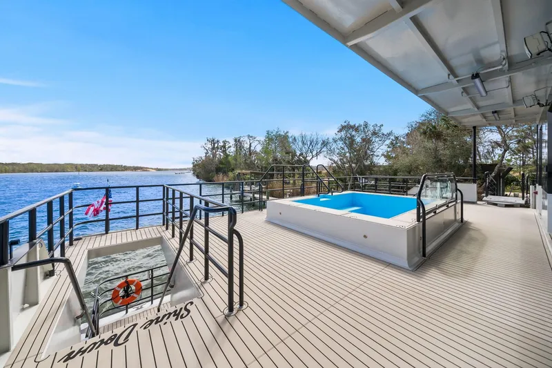 Shine Down Yacht Photos Pics Luxurious Breaux Brothers 120 GLV yacht deck with pool, overlooking serene waters, 2025 model.