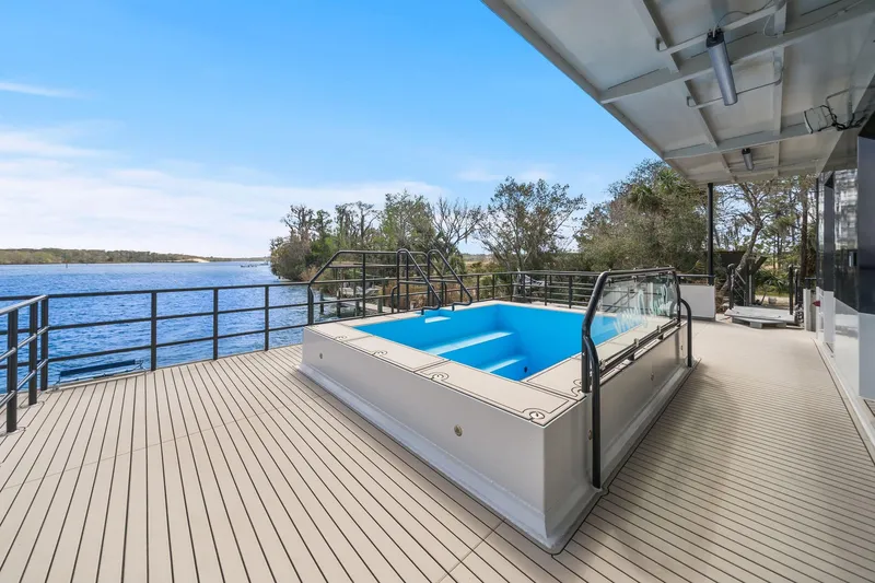 Shine Down Yacht Photos Pics Luxurious Breaux Brothers 120 GLV yacht deck with pool, overlooking serene waters, 2025 model.