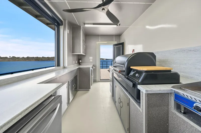 Shine Down Yacht Photos Pics Modern kitchen on Breaux Brothers 120 GLV yacht, featuring sleek appliances and ocean view.