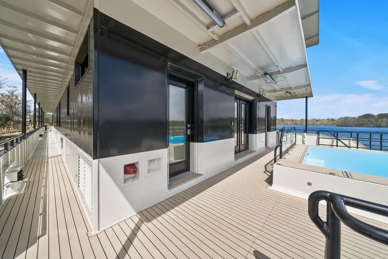 Shine Down Yacht Photos Pics Luxurious 2025 Breaux Brothers 120 GLV yacht deck with pool and scenic water view.