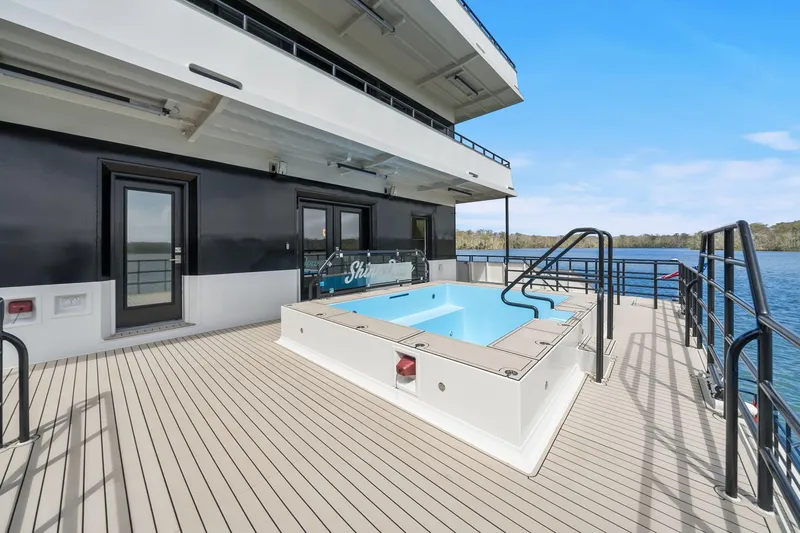 Shine Down Yacht Photos Pics Luxury yacht deck with pool, Breaux Brothers 120 GLV, 2025 model, scenic water view.