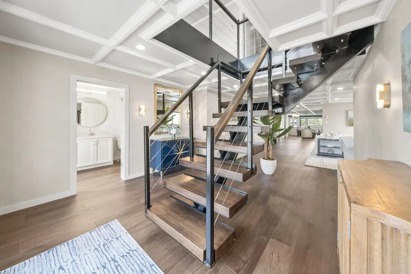 Shine Down Yacht Photos Pics Modern interior with sleek staircase, wooden flooring, and stylish decor in a Breaux Brothers 120 GLV.