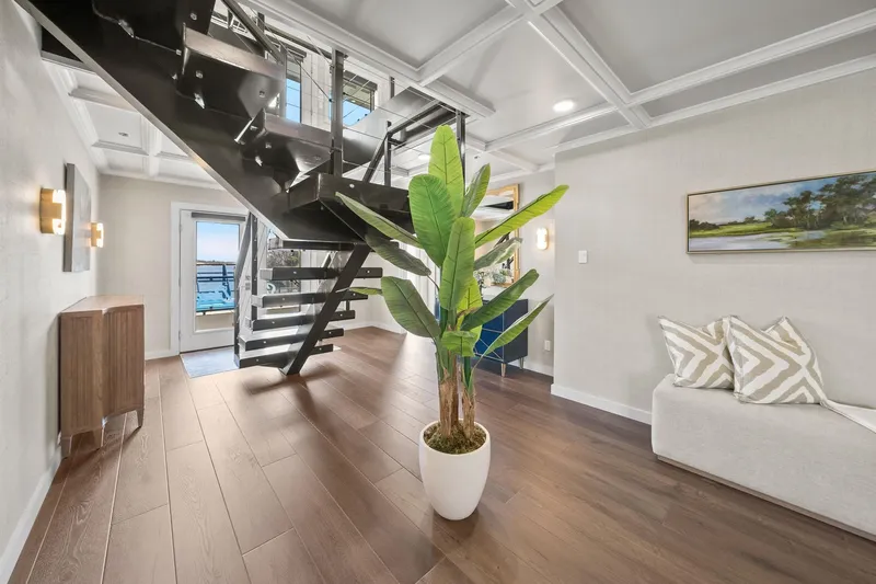 Shine Down Yacht Photos Pics Modern interior with staircase, potted plant, and wooden flooring on Breaux Brothers 120 GLV, 2025 model.