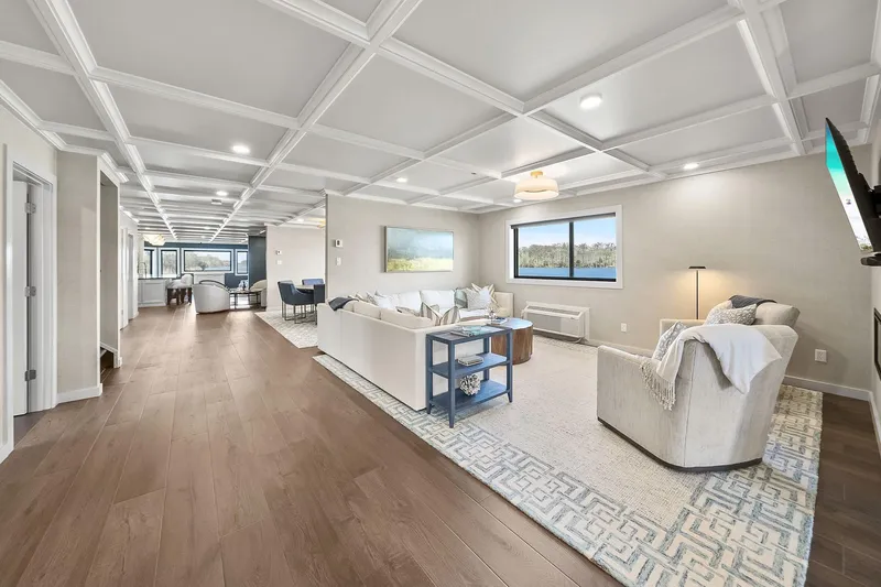 Shine Down Yacht Photos Pics Luxurious modern living room with coffered ceiling, hardwood floors, and elegant furnishings, 2025 Breaux Brothers 120 GLV.