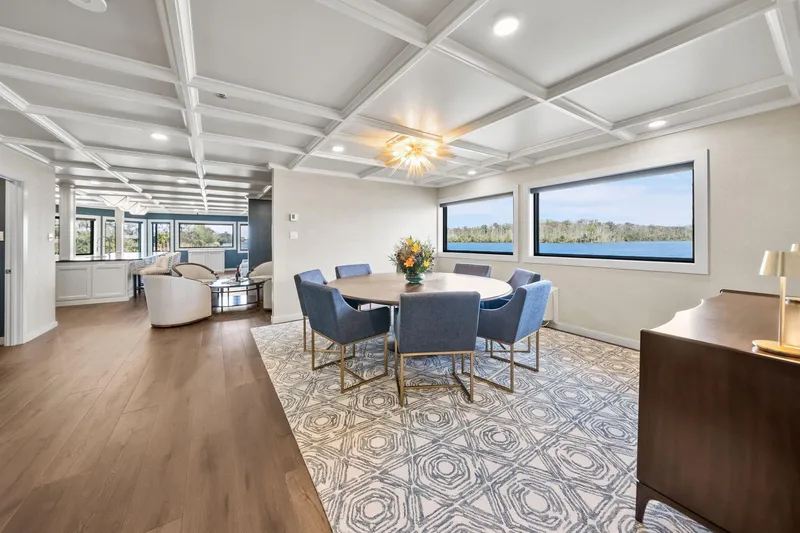 Shine Down Yacht Photos Pics Luxurious interior of 2025 Breaux Brothers 120 GLV yacht with elegant dining area and scenic views.