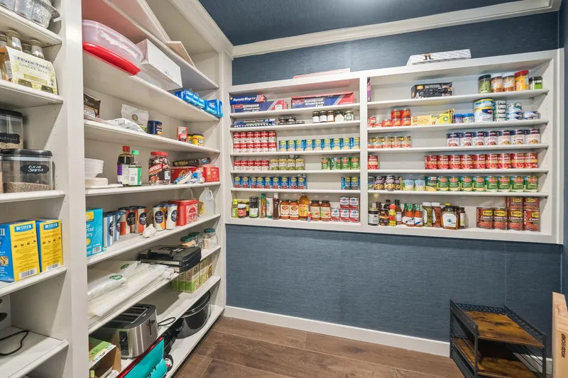 Shine Down Yacht Photos Pics Organized pantry with shelves stocked with canned goods, spices, and kitchen essentials.