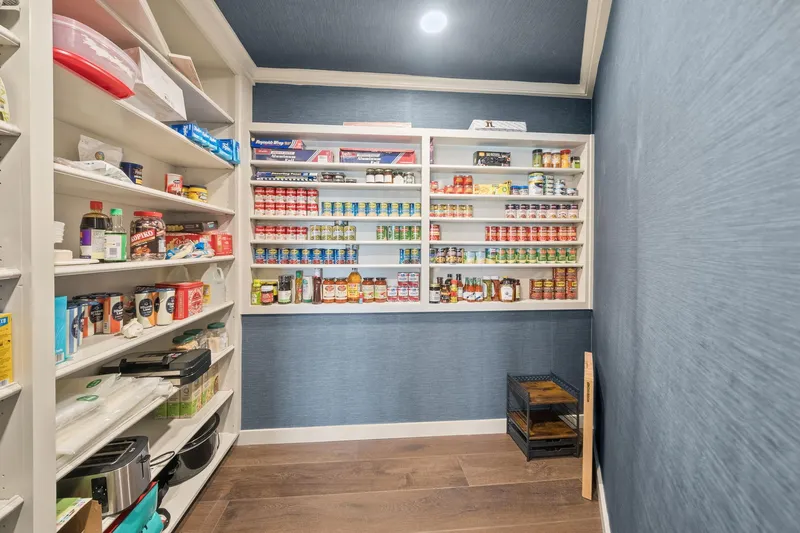 Shine Down Yacht Photos Pics Organized pantry with shelves stocked with canned goods and kitchen supplies.