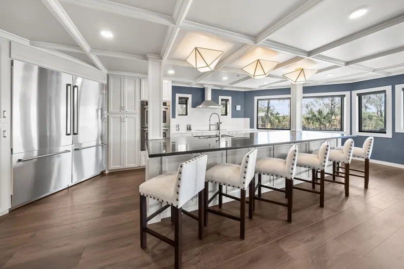 Shine Down Yacht Photos Pics Luxurious modern kitchen with island seating, stainless steel appliances, and large windows. Breaux Brothers 120 GLV 2025.