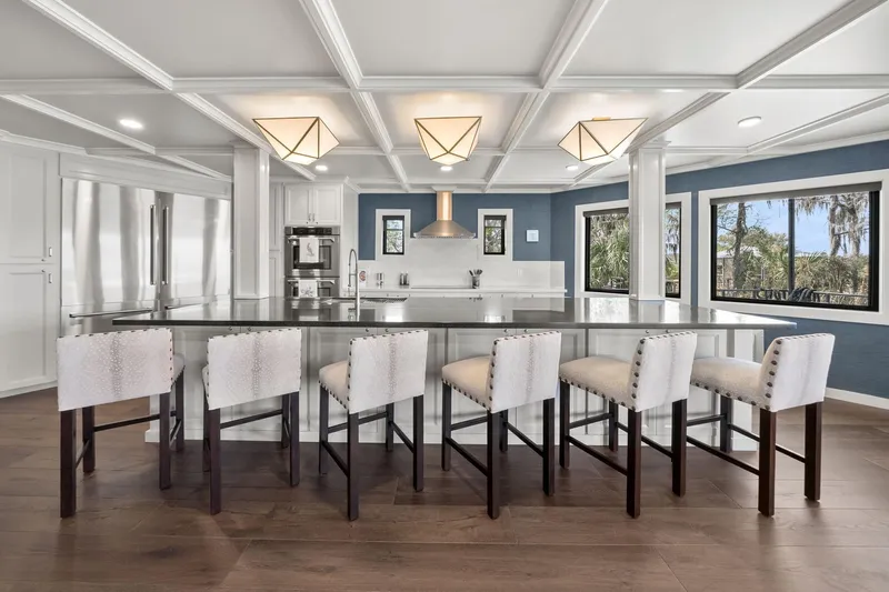 Shine Down Yacht Photos Pics Luxurious modern kitchen with island seating, elegant lighting, and scenic window views.