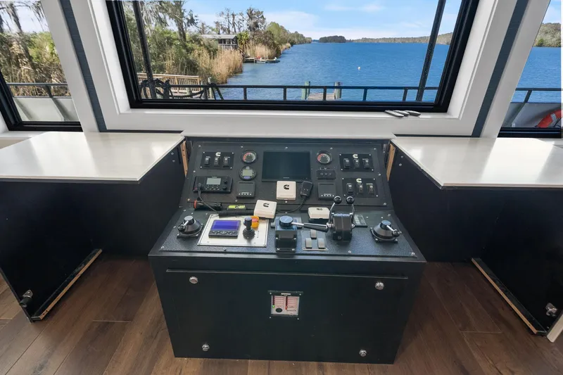 Shine Down Yacht Photos Pics Control panel of 2025 Breaux Brothers 120 GLV boat with scenic waterway view.