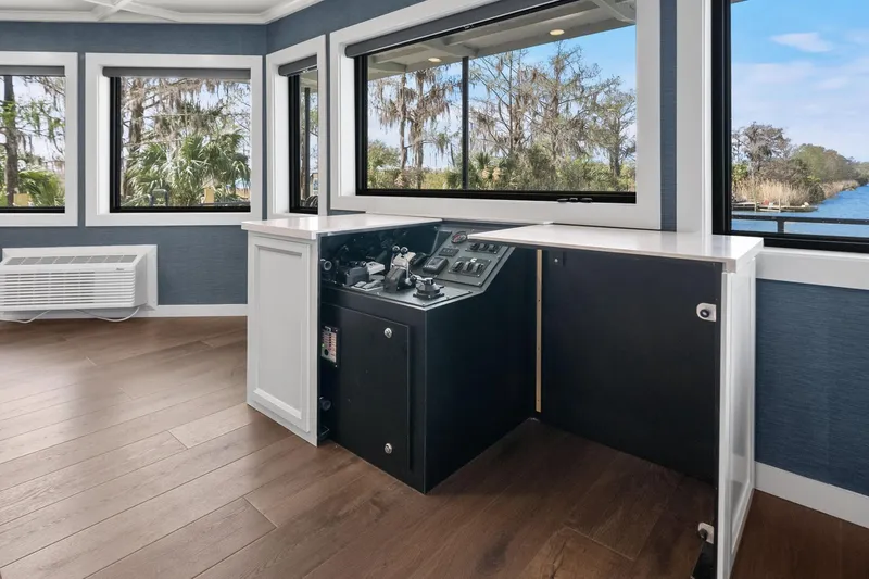 Shine Down Yacht Photos Pics Modern helm station on Breaux Brothers 120 GLV yacht, 2025 model, with scenic waterway views.