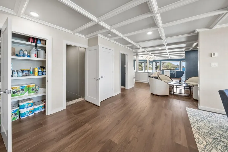 Shine Down Yacht Photos Pics Modern living space with open pantry, hardwood floors, and elegant ceiling design. Breaux Brothers 120 GLV 2025.