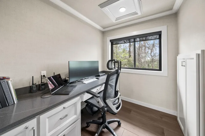 Shine Down Yacht Photos Pics Modern office space with desk, chair, laptop, and window view on Breaux Brothers 120 GLV, 2025.