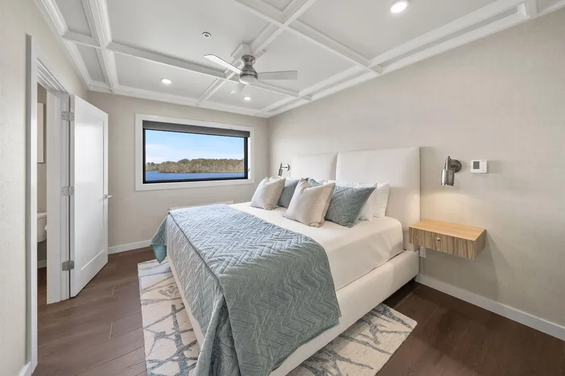 Shine Down Yacht Photos Pics Modern bedroom with elegant decor, featuring a large window and stylish bedding. Breaux Brothers 120 GLV 2025.