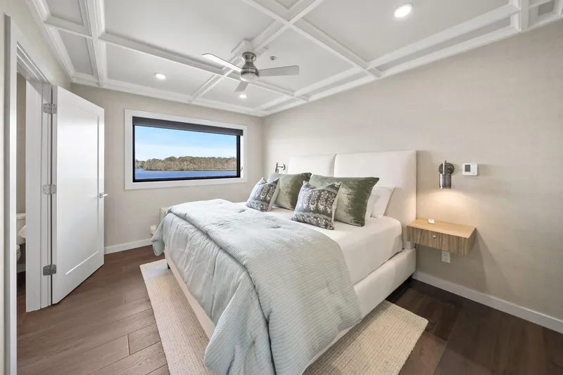 Shine Down Yacht Photos Pics Modern bedroom interior on Breaux Brothers 120 GLV yacht, 2025 model, with scenic window view.