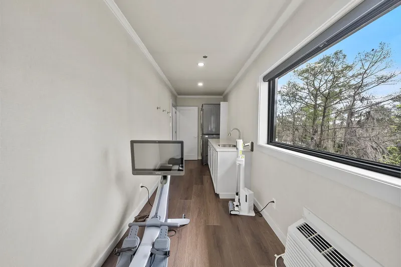 Shine Down Yacht Photos Pics Modern interior of Breaux Brothers 120 GLV, 2025 model, featuring exercise equipment and scenic window view.