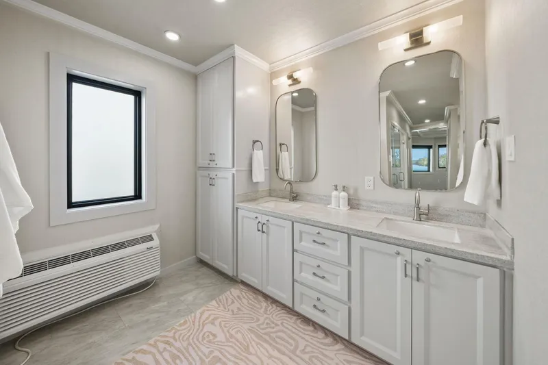 Shine Down Yacht Photos Pics Modern bathroom with dual sinks, elegant mirrors, and soft lighting in a Breaux Brothers 120 GLV, 2025.