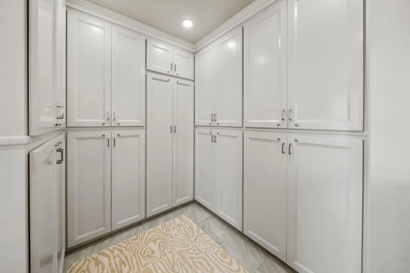 Shine Down Yacht Photos Pics White cabinetry in a modern kitchen, featuring ample storage and sleek design.