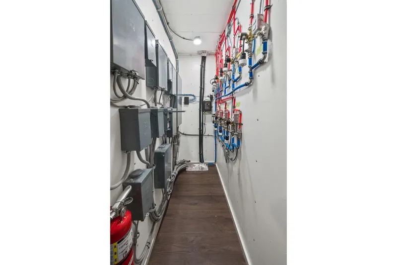 Shine Down Yacht Photos Pics Narrow utility room with electrical panels and colorful piping, Breaux Brothers 120 GLV, 2025 model.