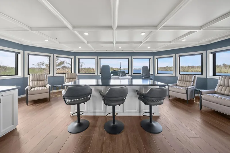 Shine Down Yacht Photos Pics Luxurious interior of 2025 Breaux Brothers 120 GLV yacht with panoramic windows and modern seating.