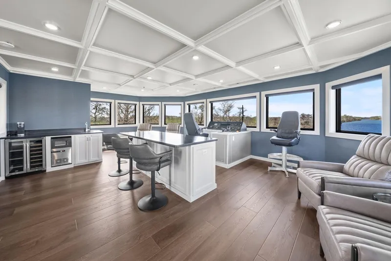 Shine Down Yacht Photos Pics Luxurious interior of 2025 Breaux Brothers 120 GLV yacht with panoramic windows and modern seating.