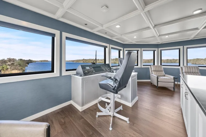 Shine Down Yacht Photos Pics Pilothouse interior of 2025 Breaux Brothers 120 GLV, featuring panoramic windows and modern seating.