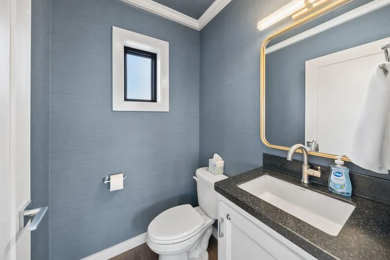 Shine Down Yacht Photos Pics Modern bathroom with blue walls, sleek fixtures, and a large mirror.