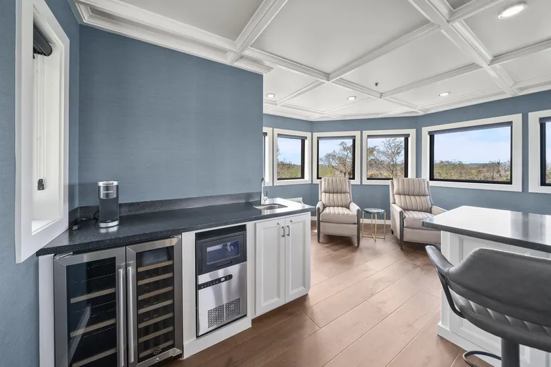 Shine Down Yacht Photos Pics Luxurious interior of 2025 Breaux Brothers 120 GLV yacht with modern seating and kitchenette.