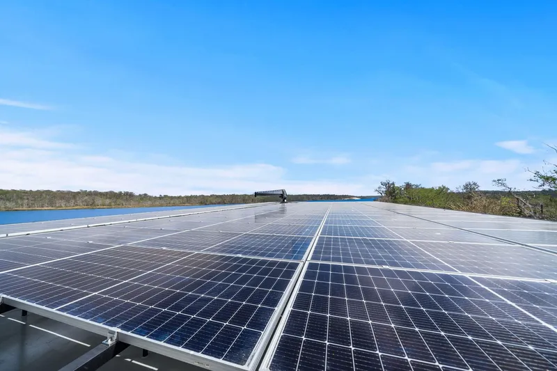 Shine Down Yacht Photos Pics Solar panels on Breaux Brothers 120 GLV boat, 2025 model, with scenic water view.